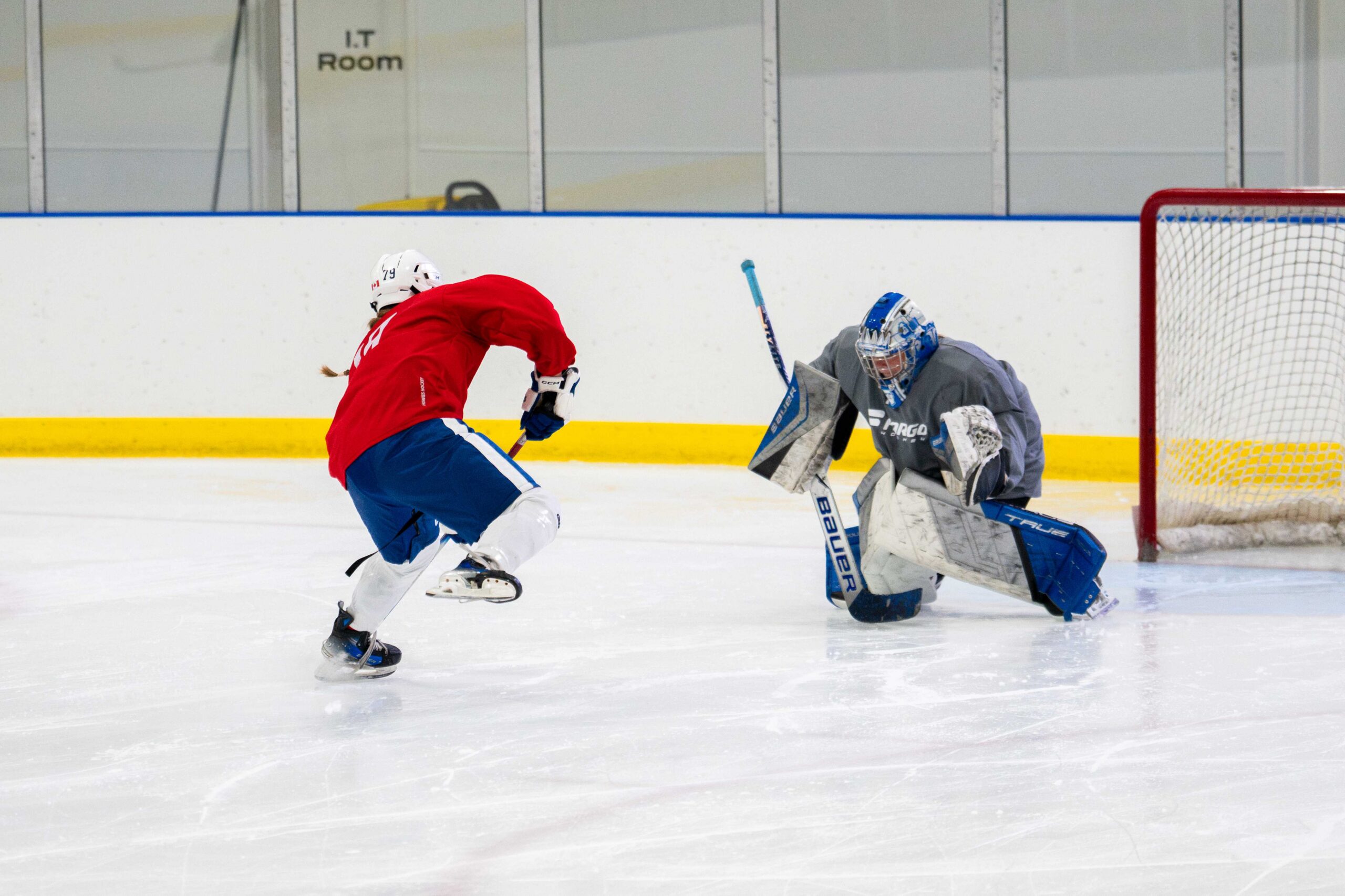 Player taking a breakaway on the goalie during camp