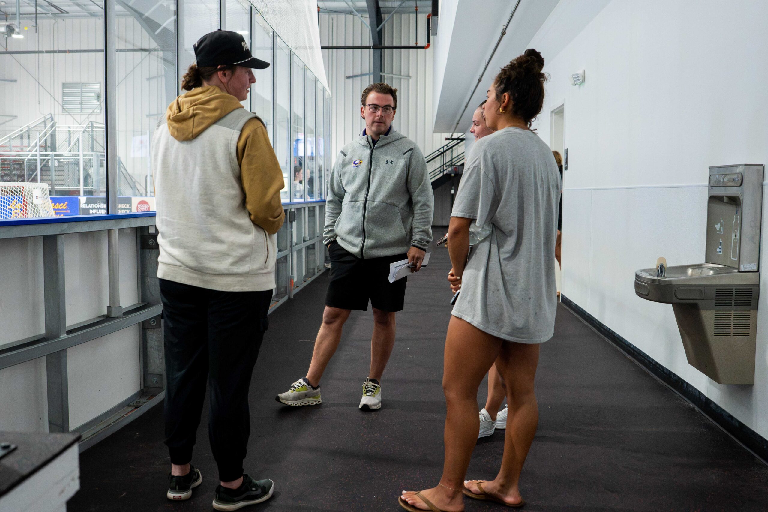 College coaches talking with campers off the ice