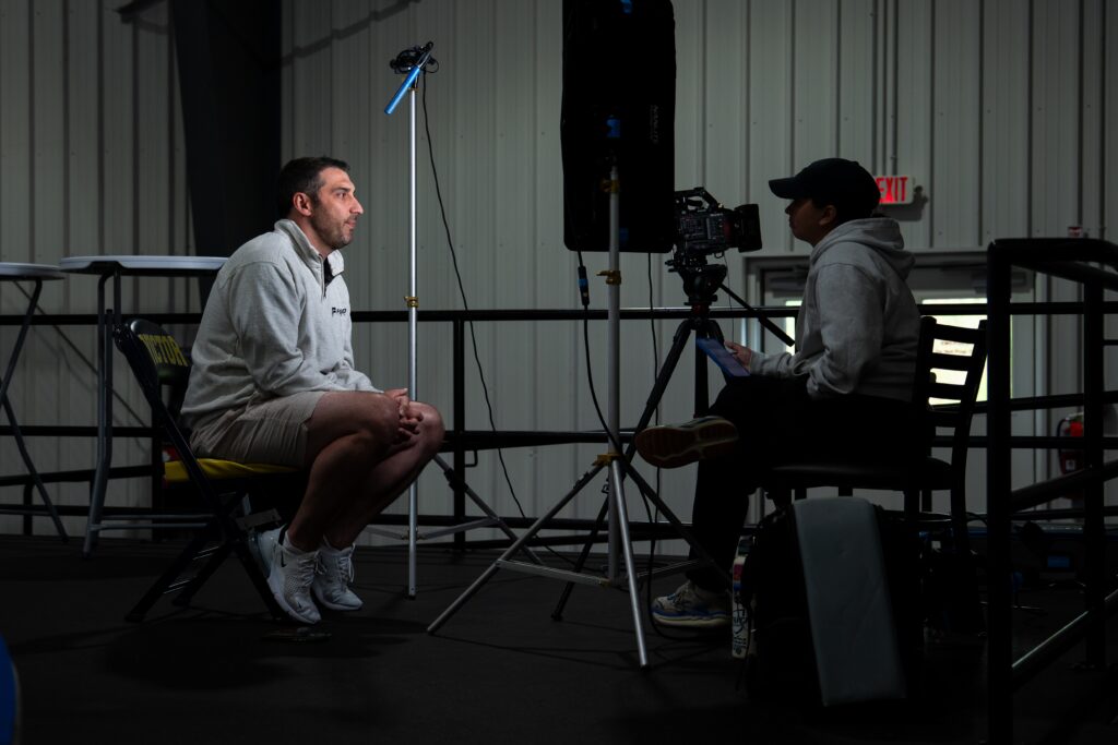 Camper being interviewed on camera at the rink