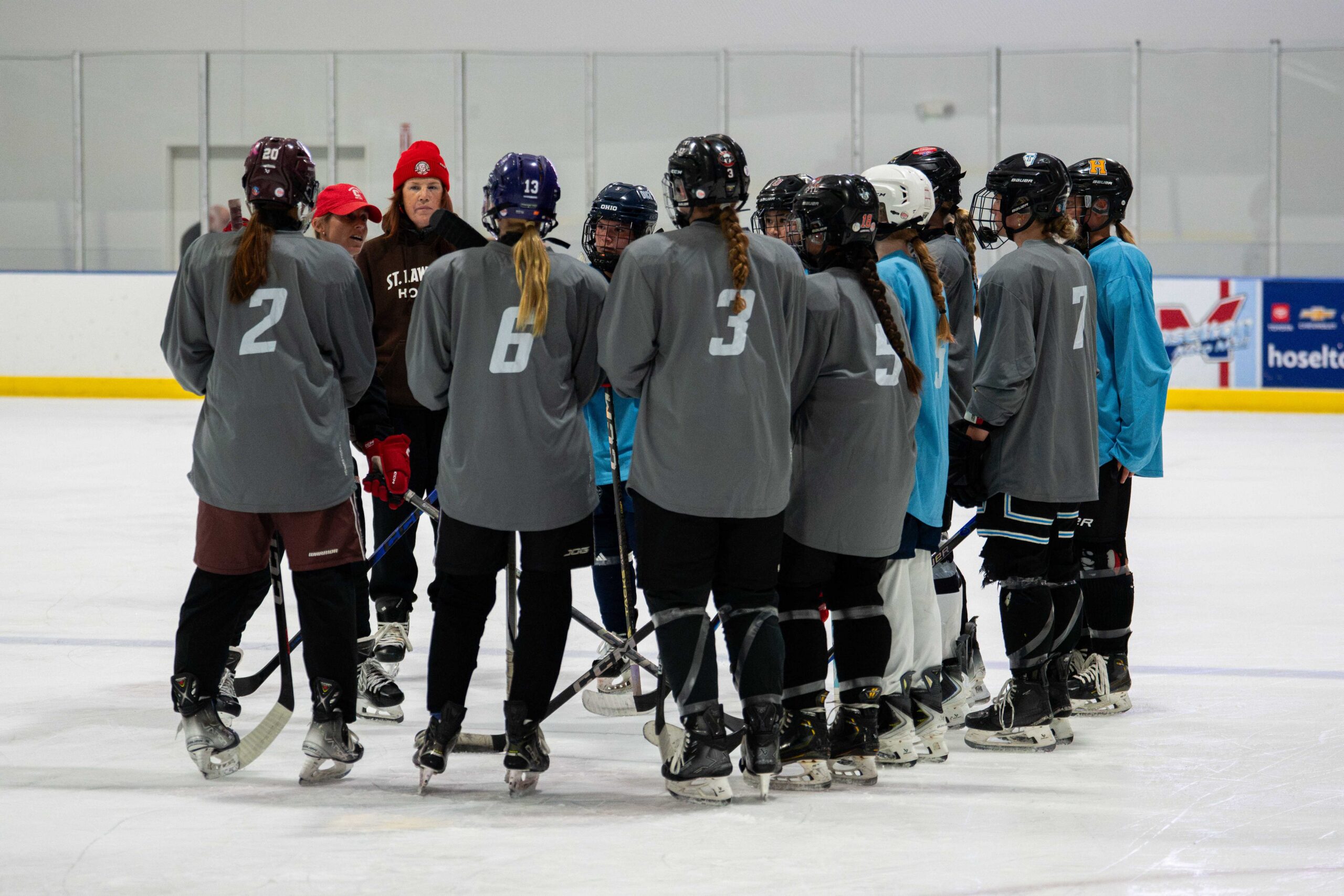 Coaches addressing a group of campers in a team huddle